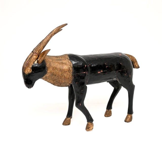 An incredibly beautiful and rare antique solid wood parcel gilt life size sculpture of an Ibex. This unusual and...