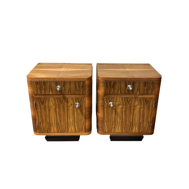 Set of two Art Deco nightstands, Central Europe, 1930s. Spruce and plywood veneered in walnut root veneer, ebonized socle,...