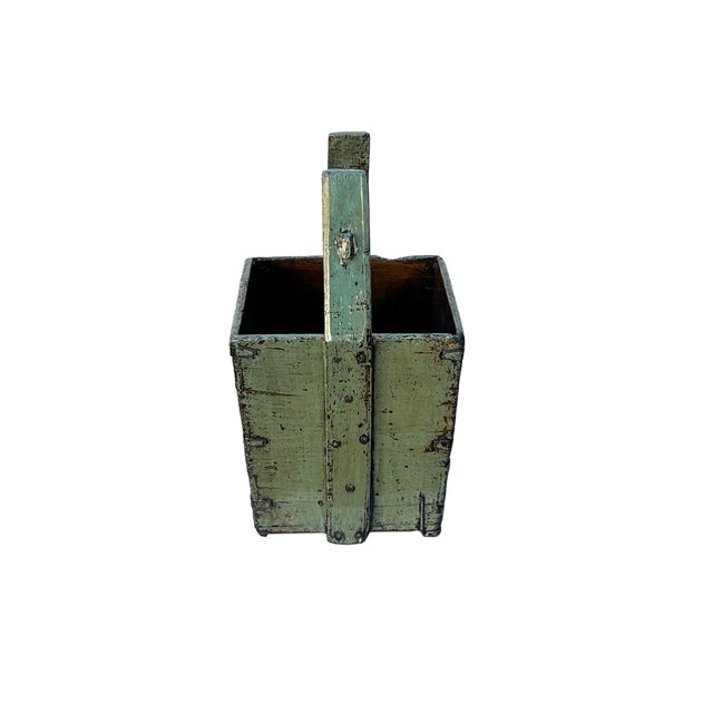 This rustic wooden bucket exudes a timeless, weathered charm, showcasing the beauty of aged craftsmanship. Constructed...