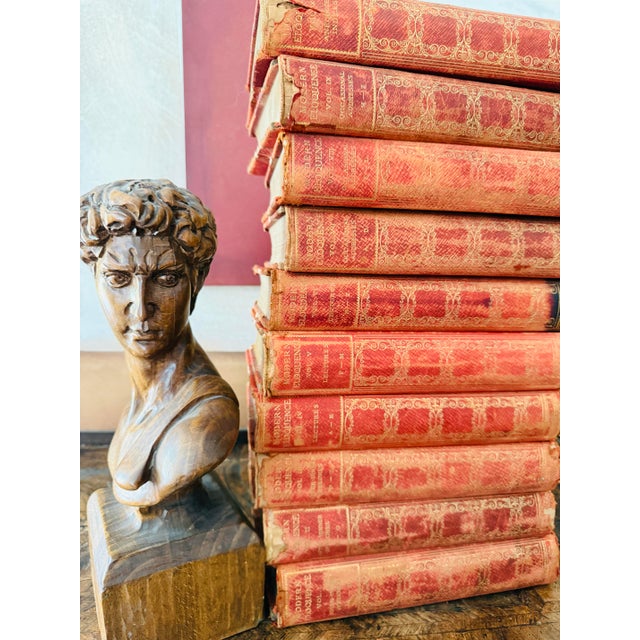 A striking full set of ten Modern Eloquence volumes, published in 1900, bound in richly detailed red leather with ornate...