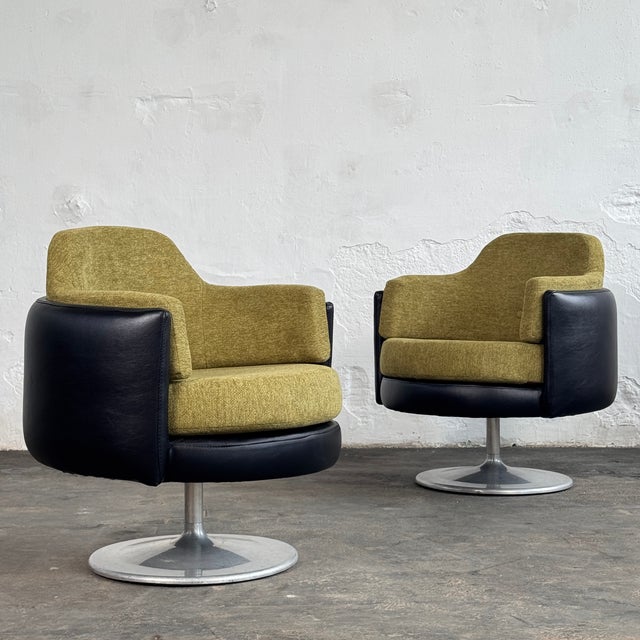This pair of swivel chairs is a bold example of Space Age design from Hungary, featuring a mix of leather and fabric...