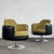 This pair of swivel chairs is a bold example of Space Age design from Hungary, featuring a mix of leather and fabric...