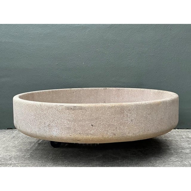 This monumental vintage stone disc planter makes a strong sculptural statement in an outdoor setting. The broad circular...