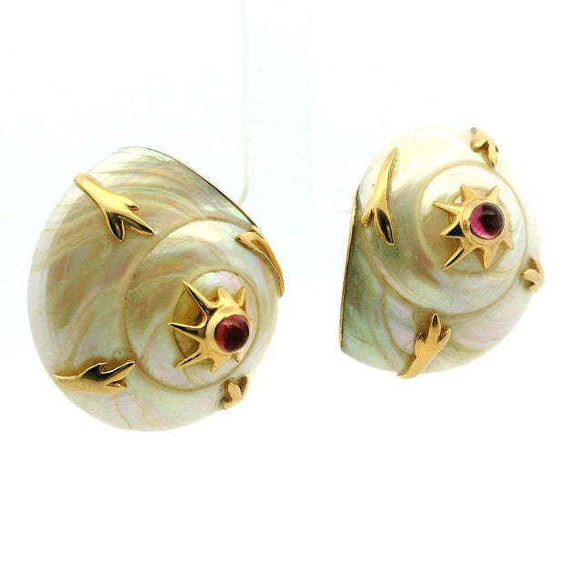 A striking pair of vintage earrings by MAZ, crafted in 14 karat yellow gold and centered on beautifully carved natural...