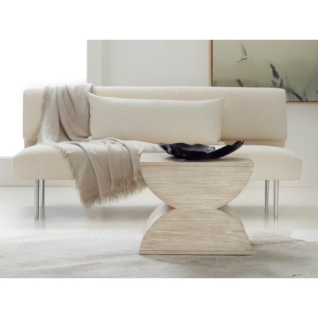 The distinctive silhouette creates a bold geometric statement, while the light ash wood finish brings a contemporary...