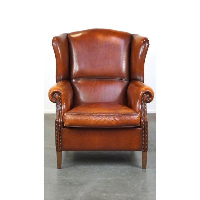 This beautiful and comfortable sheep leather wing chair with a great patina. This beautiful wing chair is made of sheep...