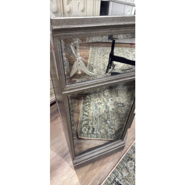 Elegant 1930s French–style mirrored nightstand from Restoration Hardware. Features antiqued mirror drawer fronts, subtle...