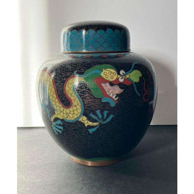 A vibrant vintage Chinese cloisonné ginger jar featuring a colorful dragon design. Crafted with intricate enamel work and...