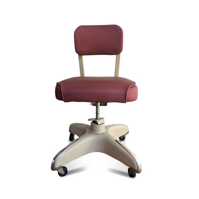 A restored mid-century tanker chair by Cole-Steel. The industrial office chair features a metal frame, new red vinyl...