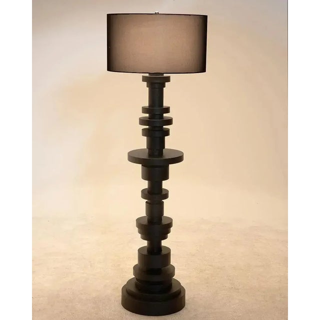 Variegated discs of metal in a rich black finish are stacked to create the bases of these extraordinary lamps. Each of the...