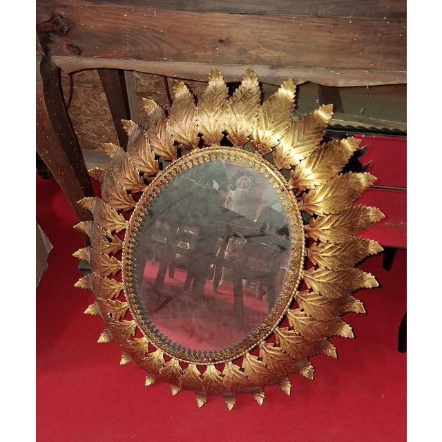 Sunburst Mirror in Gilt Metal with Leaf Decoration Work, 1960s, in Good conditions. Designed 1960 to 1969