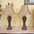 Handsome pair of vintage Uttermost urn-form table lamps with a richly textured, carved wood-look finish. Likely late...