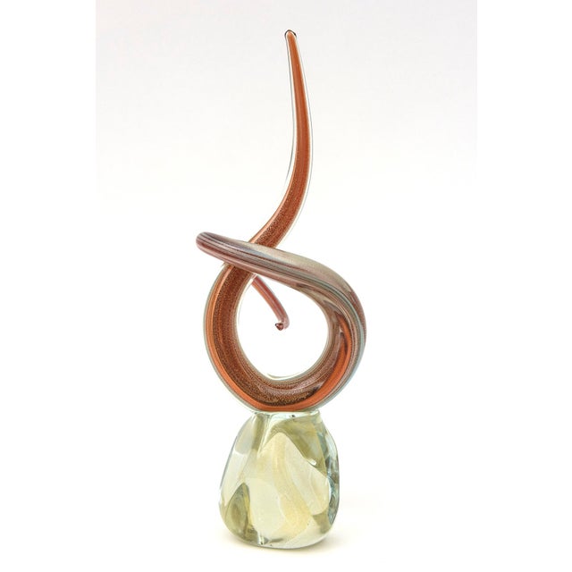 This vintage signed limited edition twisted glass sculpture are colors and shades of orange, to burnt orange with white...