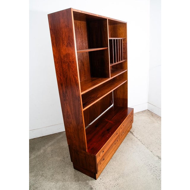 Poul Hundevad 2 piece cabinet in rosewood. The bottom offers 2 drawers while the top offers vinyl storage and shelving....