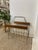This vintage mid-century modern magazine rack combines clean lines with a warm material palette, showcasing hallmark...