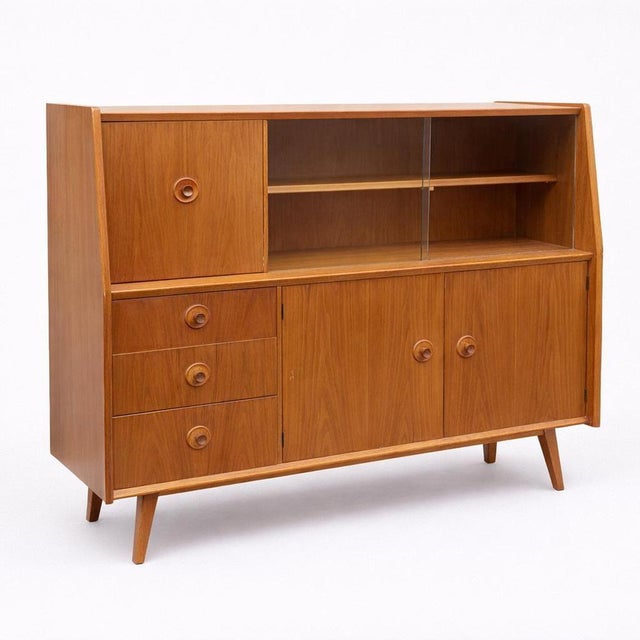 A stylish mid century drinks cabinet by Priory, crafted in a beautiful combination of oak and walnut. The design features...
