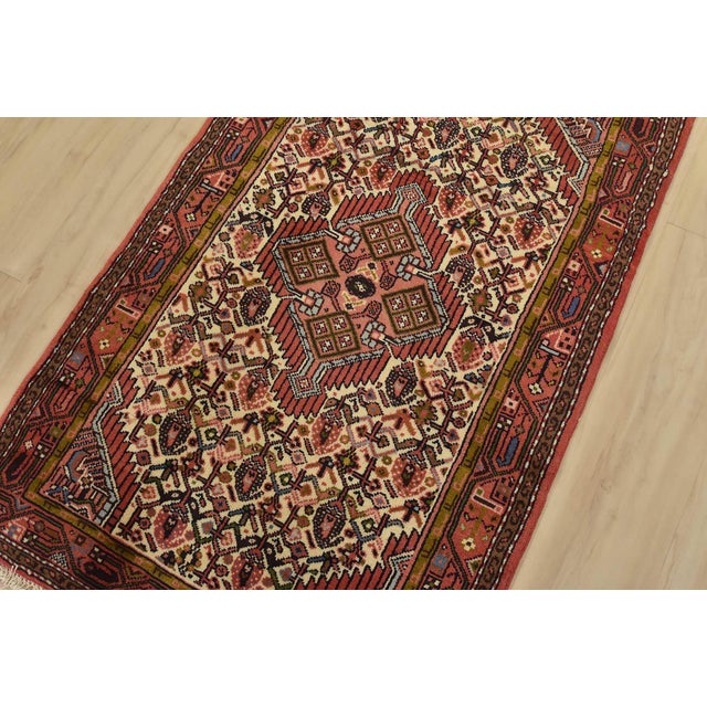 An authentic vintage tribal Hamedan rug hand-knotted with fine wool and natural dyes. This nomadic rug features a central...