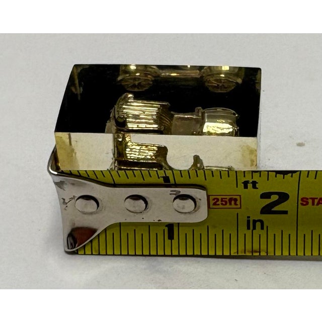 Vintage mid-century lucite paperweight featuring an encased antique-style automobile. Solid clear lucite with a warm amber...