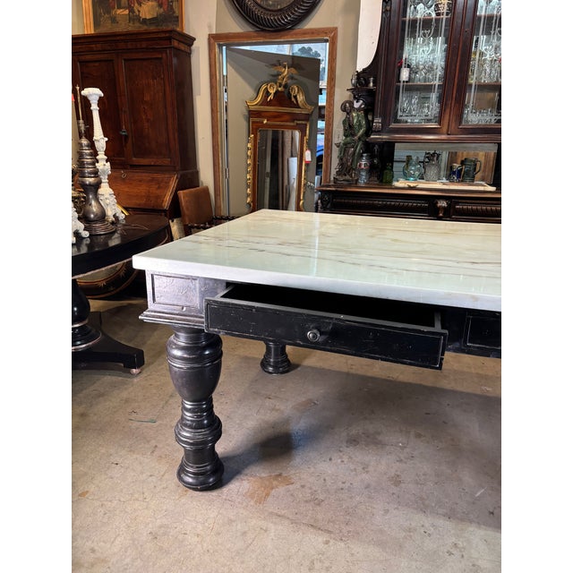 Industrial, midcentury, library table features a marble top with contrasting, black lacquered legs and apron. The table...