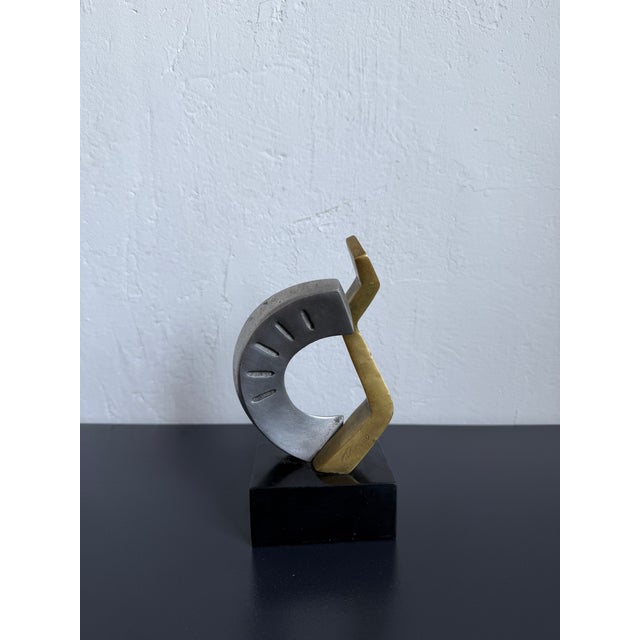 Abstract geometric bronze and aluminum sculpture on black base by Brazilian plastics artist Palermo, 1990s.