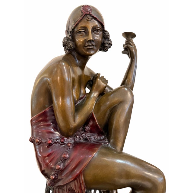 An exquisite and visually striking Art Deco style figurative bronze sculpture titled "Champagne Girl" (or Champagne...
