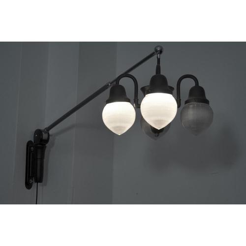 Rare big boom lamp for wall mounting. The four lights are separated switchable to two. Through the articulated arm, the...