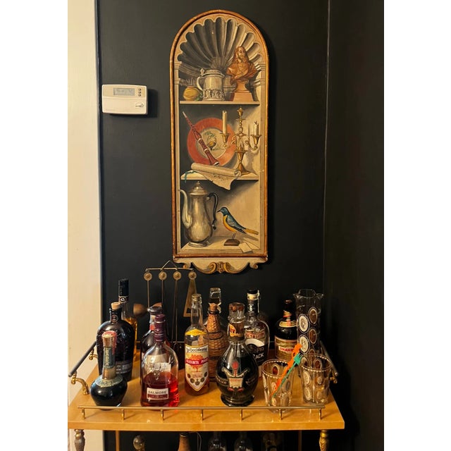 A hand painted Italian wall plaque by Palladio from the mid 20th century, an Italian brand. The panel has a "trompe...