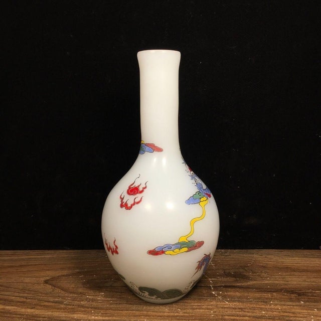 An elegant hand-painted opaque white glass vase, featuring a vivid double dragon chasing pearl design. The slender...