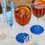 Collection for the table in clear colored glass. It includes tumblers for water and soft drinks, wine glasses, flute...