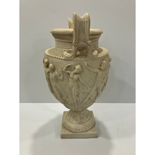 This large plaster urn features figures surrounding all sides. At 20.25 inches in height it has a strong sculptural...