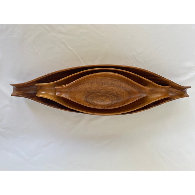 1960's sculptural Monkey pod wood tray set all carved by hand in the Philippines, signed on bottom. Set of 4. Ideal for...