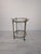 French Mobile Brass Bar from the 1950s This mobile brass bar table from the 1950s features two glass shelves on wheels for...