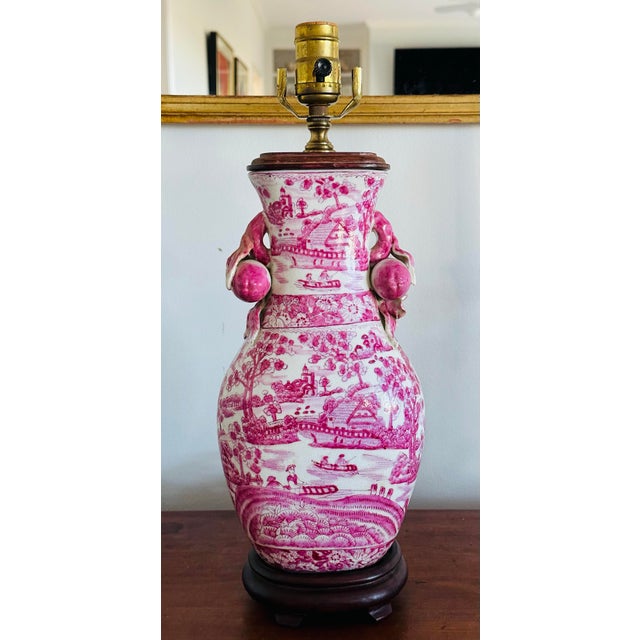 Lovely vintage Chinoiserie Pink Chinese Porcelain Table Lamp decorated with pomegranates and flower handles. Warm pink...
