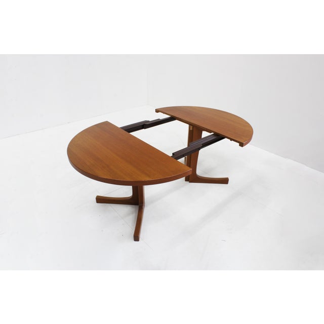 Vintage Danish round extendable dining table from the 1960s made of teak wood. This Danish dining table can be extended to...