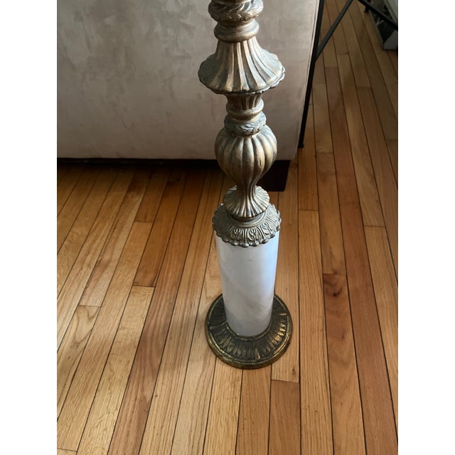 Vintage Hollywood Regency style end table. This table measures 35” tall. The top is constructed of marble, with a marble...