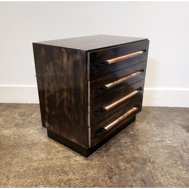 Four-drawer wood chest with black metal laminate base and modern pulls refinished by artist Lionel Lamy. Rich dark surface...