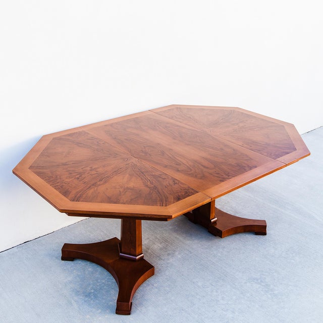 Expertly refinished walnut burl octagonal dining table on split pedestal base, made by Baker in the United States c....