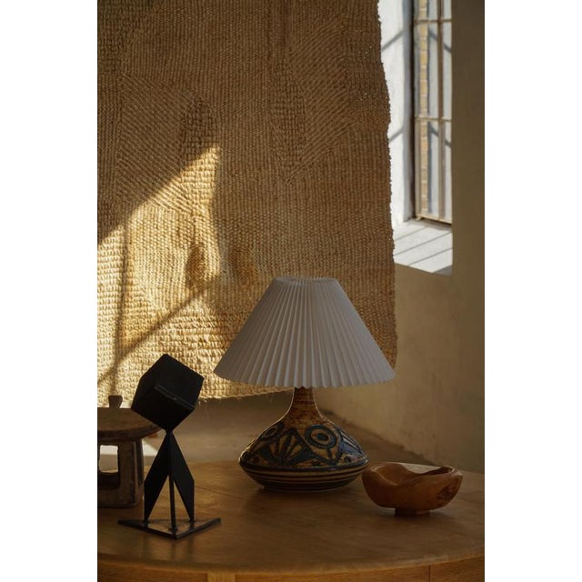 Expressive danish modern table lamp produced by søholm, denmark, in the 1960s. The lamp features a wide, low-profile form...