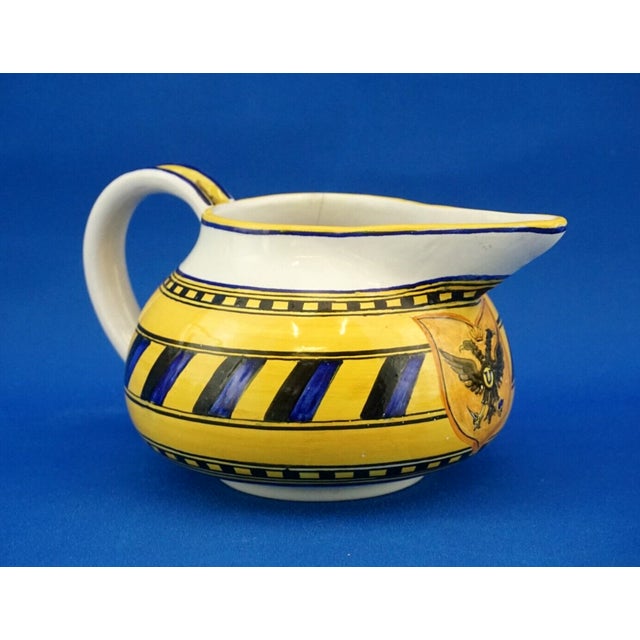 A magnificent majolica ceramic jug, entirely hand-crafted on a wheel, glazed and decorated by hand underglaze, signed...