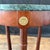 Elegant pair of French style Neoclassical side tables, each featuring a circular dark green verde marble top above a...