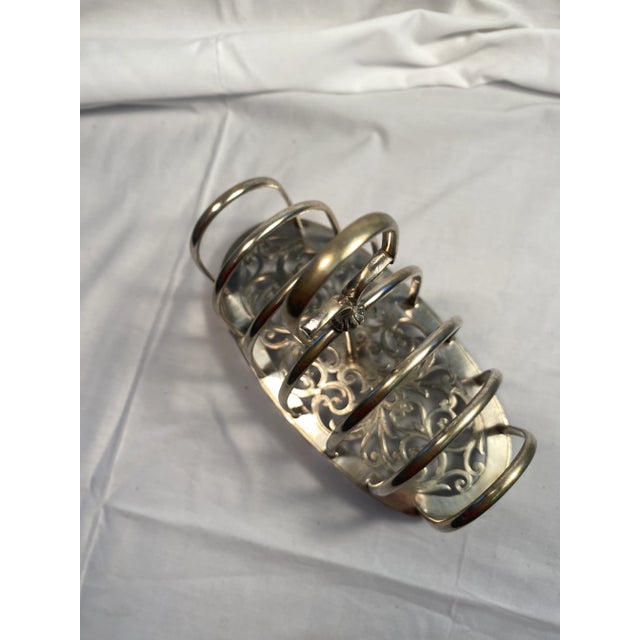 This Victorian silver plate toast rack has it all. Great attention to detail. Stunning scroll work, footed bottom, and six...