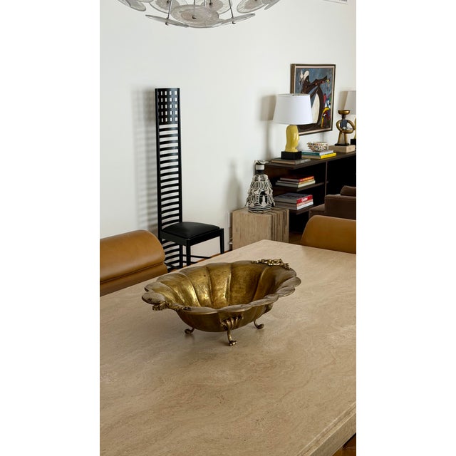 We are very pleased to offer this striking vintage brass centerpiece bowl, circa Mid-20th Century. Substantial in both...