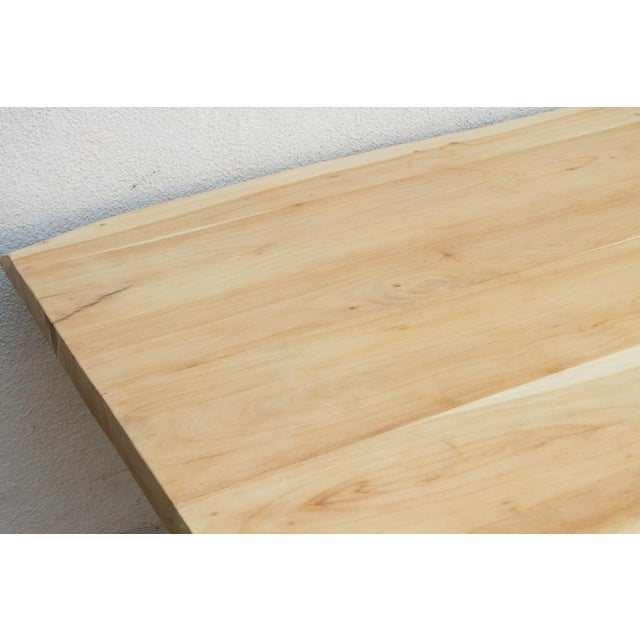 This dining table brings the sun-bleached textures of the California coastline into a solid, architectural form. Hand-...