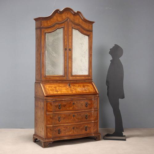 Trumeau in walnut, burl walnut, and maple trim. The top features mirrored doors, three interior shelves, an open...