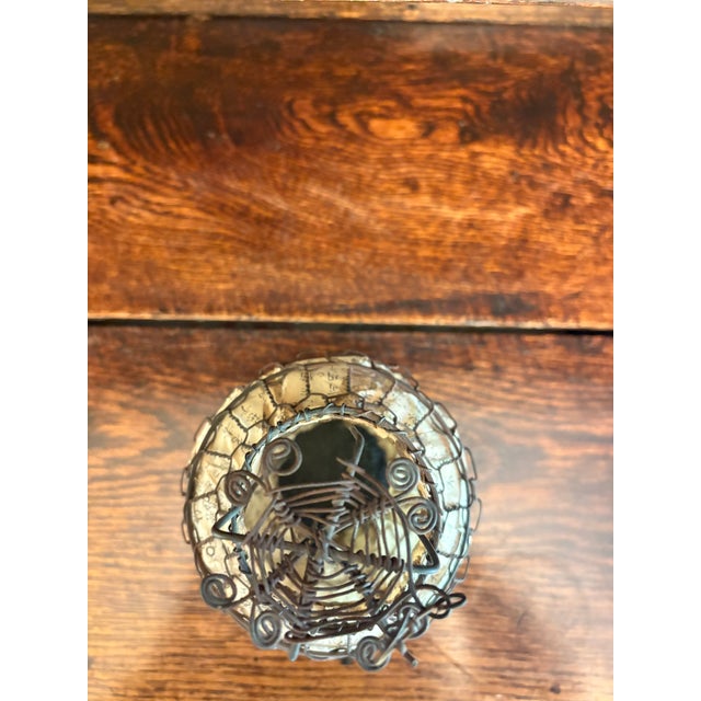 This vintage Chinese lantern features a hand-assembled wire frame wrapped in printed paper panels adorned with traditional...