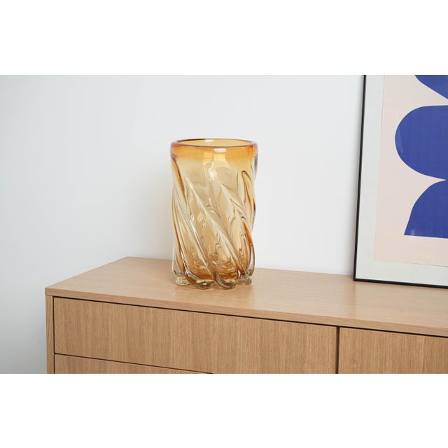 The vase was made in the 1960s in Italy. An impressive vase with a sculptural form, made of thick, blown glass in a honey...