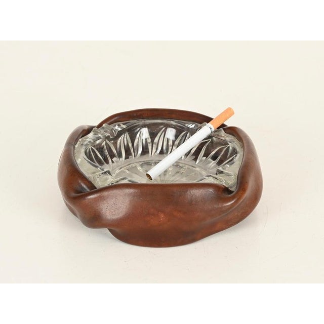 Spectacular Mid-Century Italian ashtray fully made of thick curved brown leather and cut crystal glass. This stylish piece...