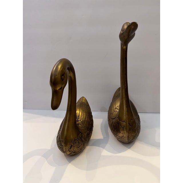 Vintage pair of brass swans. Great accent pieces to add a little whimsy to a bookcase or sideboard. Would be fun in the...