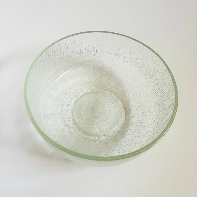 A large mid century glass salad bowl made in the "Crystal Ice" pattern by Indiana Glass. Made of clear glass with an icey...