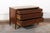 An elegant French Neoclassical period wooden commode with brass accents and marble top, dating from the early 19th...